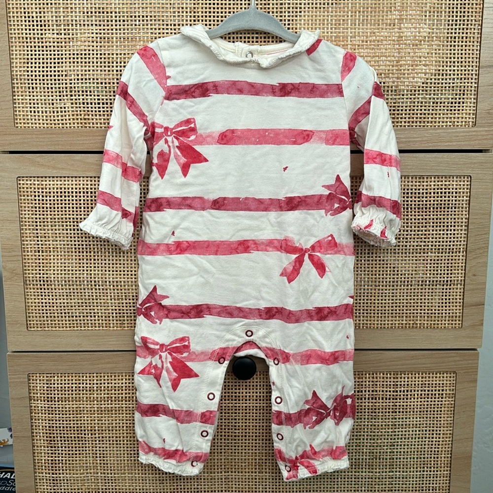 Burt’s Bee’s holiday bow romper with ruffles at neck, arm and leg openings